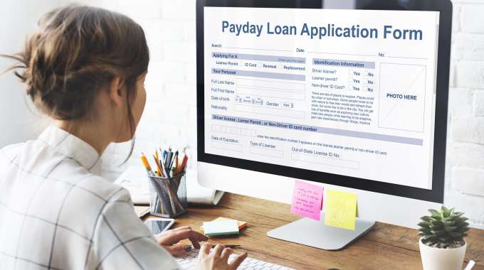 woman thinking about applying for a payday loan