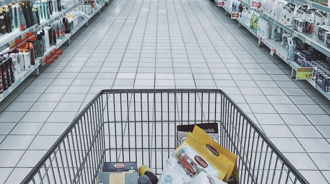 person grocery shopping using coupons