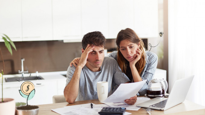 Young couple looks despondent trying to get approved for a loan online
