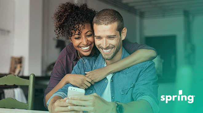 Couple using cash advance app on phone